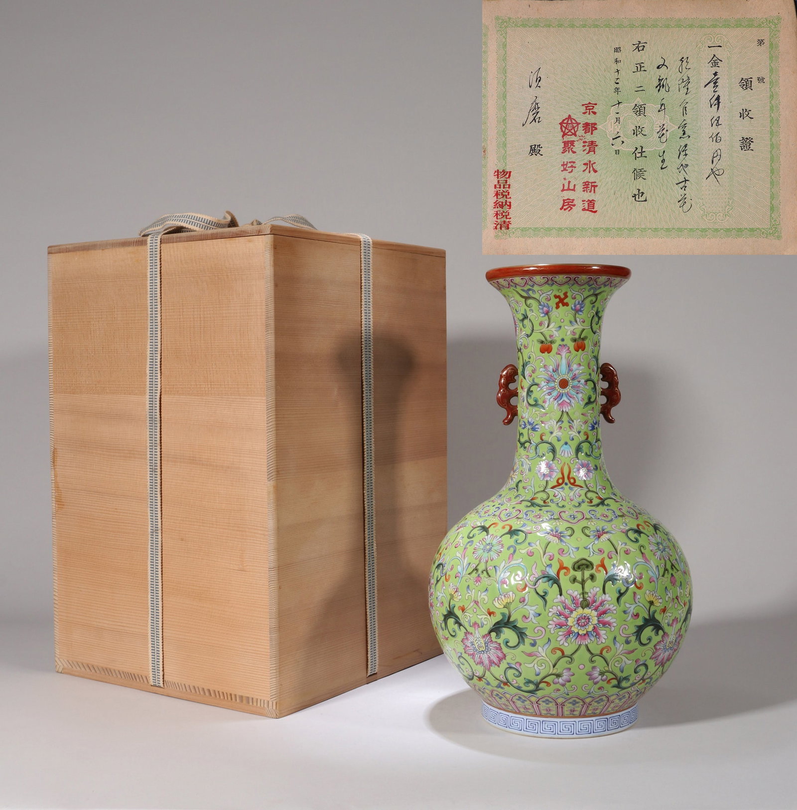 AN APPLE GREEN-GROUND FAMILLE ROSE 'FLOWERS' DOUBLE-HANDLE VASE