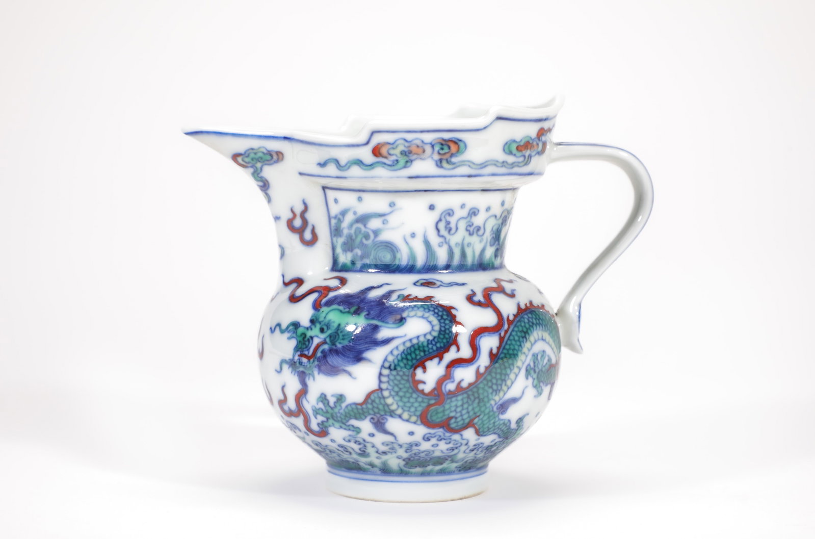 A DOUCAI 'WAVES AND DRAGON' MONK'S-CAP EWER