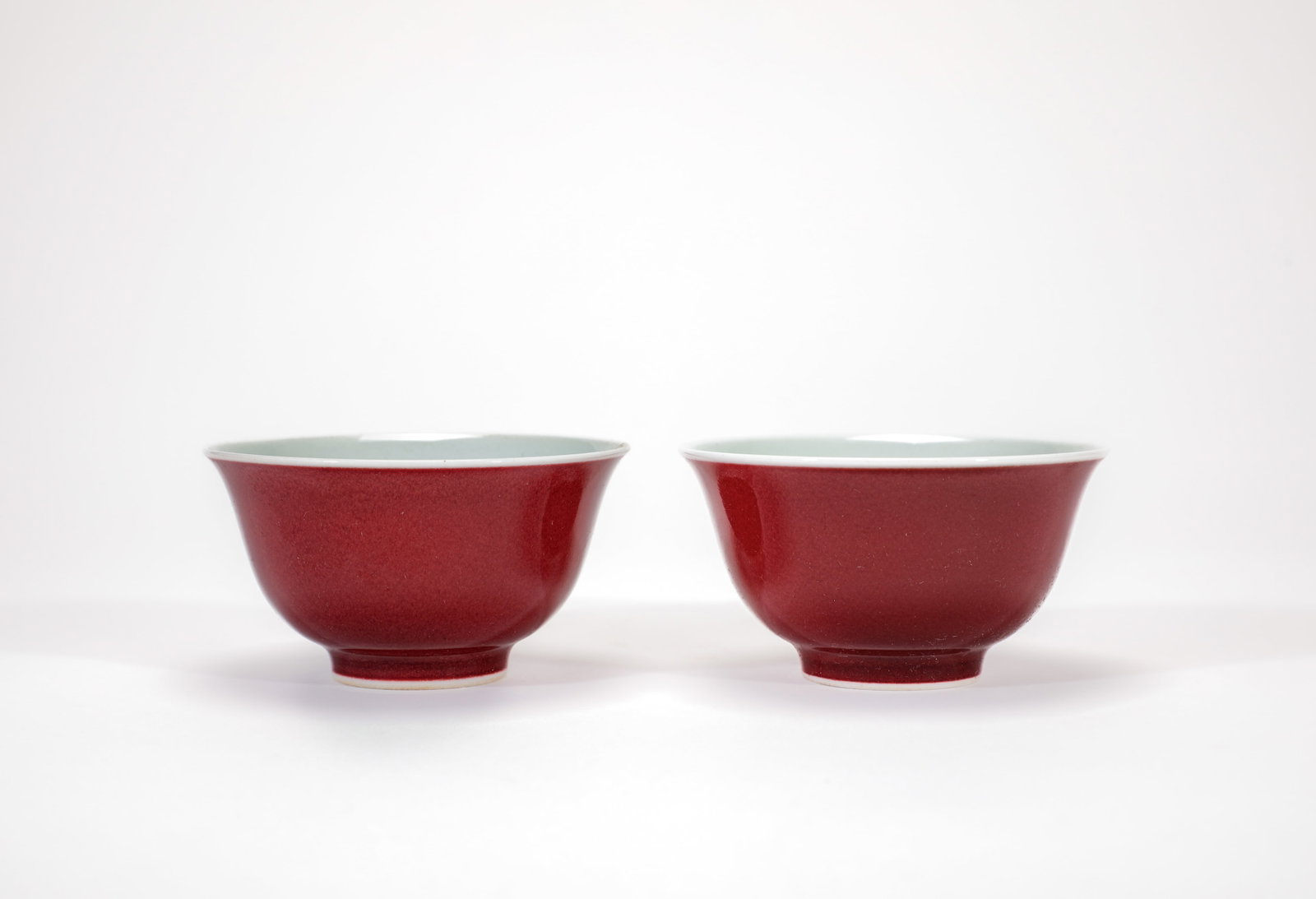 A PAIR OF SACRIFICIAL RED-GLAZED 'PLAIN' CUPS (1 of 8)