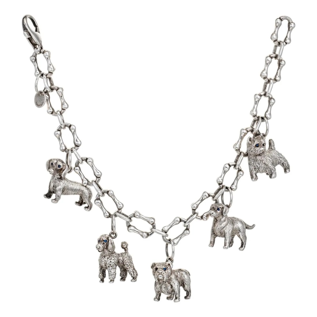 DOG MOTIF CHARM BRACELET, STERLING SILVER: DOG MOTIF CHARM BRACELET, STERLING SILVER Description: The bracelet is composed of a continuous chain of bone-shaped links, each forming an elongated oval with rounded protrusions that evoke the form 