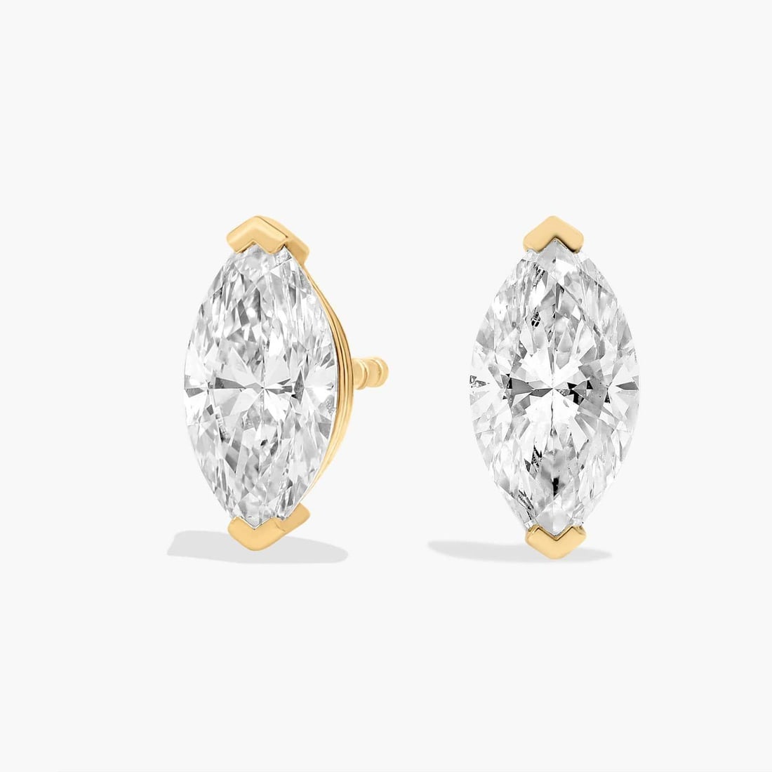 MARQUISE CUT DIAMOND STUD EARRINGS IN 14K YELLOW GOLD: MARQUISE CUT DIAMOND STUD EARRINGS IN 14K YELLOW GOLD Description: Sparkle with every movement of your head when you wear these classic stud earrings set with marquise-cut diamonds. The 14k yellow gol