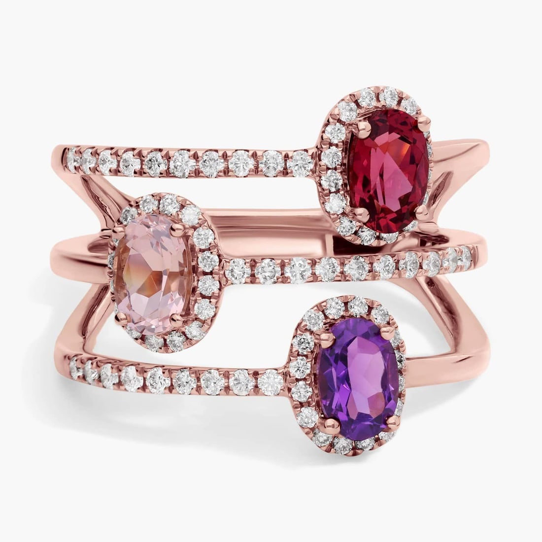 THREE STONE FAUX STACKING RING IN 14K ROSE GOLD: THREE STONE FAUX STACKING RING IN 14K ROSE GOLD Description: This ring features amethyst, morganite and rhodolite garnet gemstones that sparkle in a split design that splays it into the appearance of 