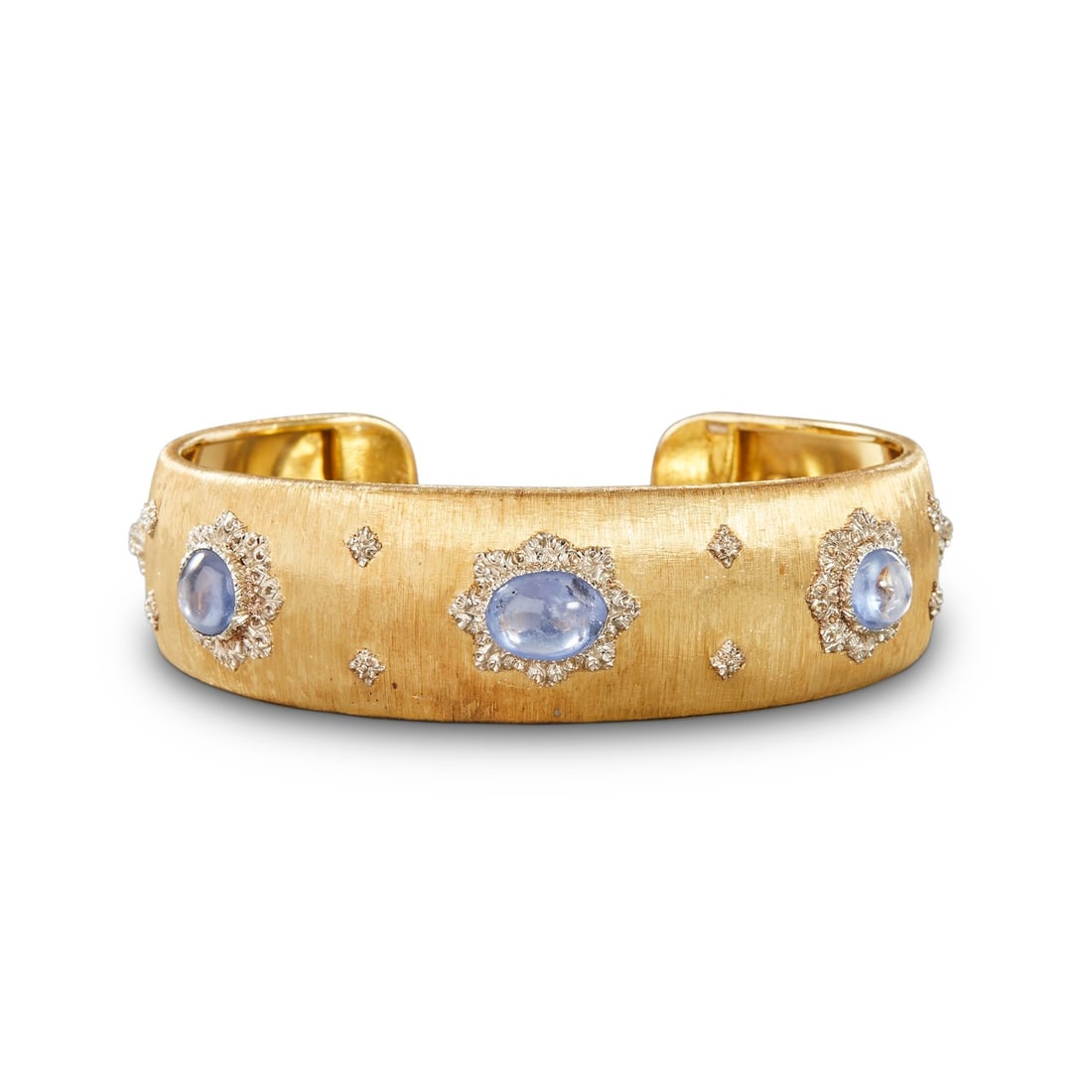 GEM-SET YELLOW METAL CUFF BRACELET: GEM-SET YELLOW METAL CUFF BRACELET Description: A wide yellow metal cuff bracelet with textured surface decoration and alternating cabochon and light-colored stones. The images document the bracelet f
