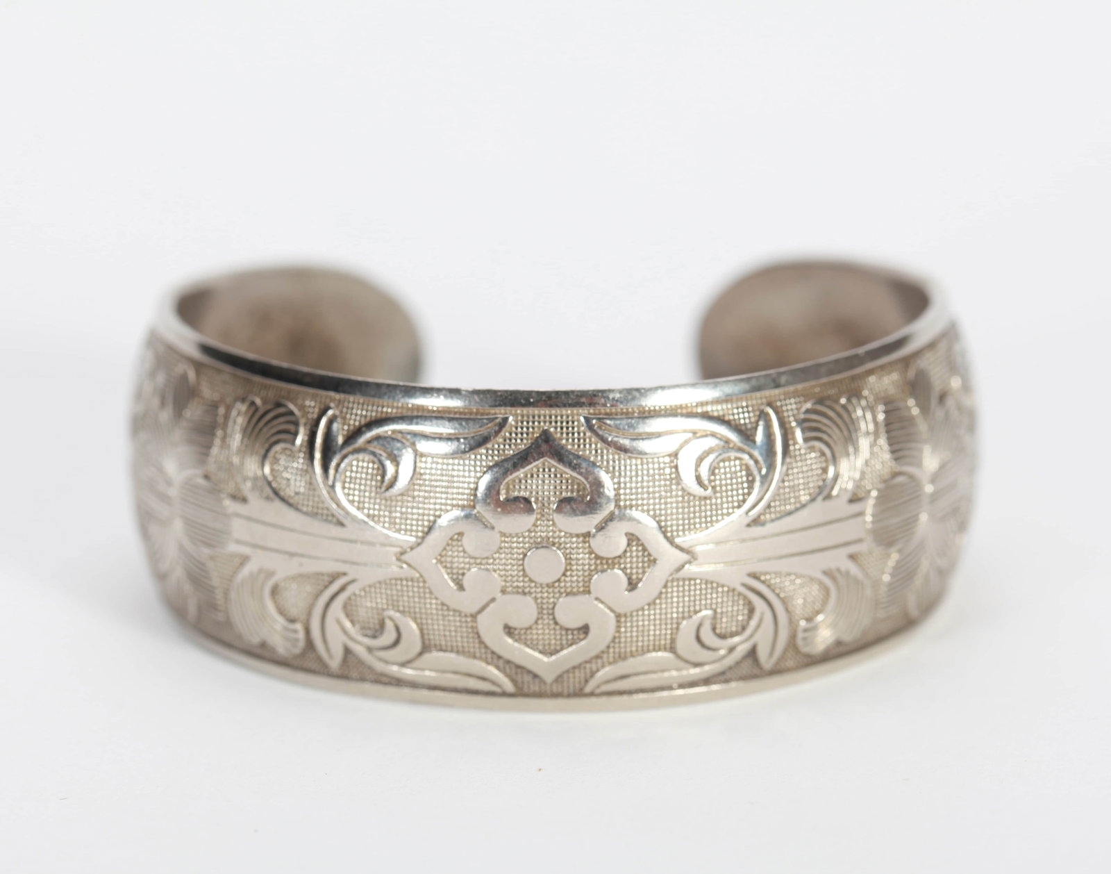 A SILVER BANGLE: A SILVER BANGLE Dimensions: Diameter: 6.5 cm (2.56 in.). All measurements are approximate.