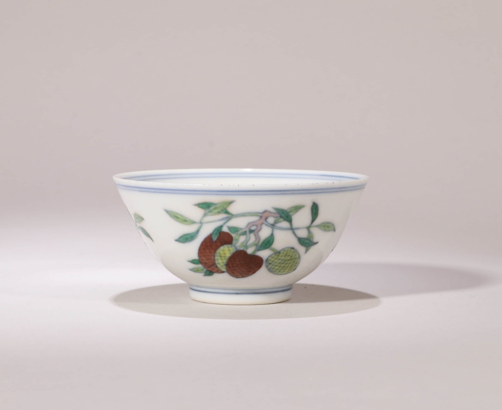A DOUCAI 'THREE FRUITS' BOWL: A DOUCAI 'THREE FRUITS' BOWL Dimensions: Diameter: 9 cm (3.54 in.), Height: 5 cm (1.97 in.). All measurements are approximate.