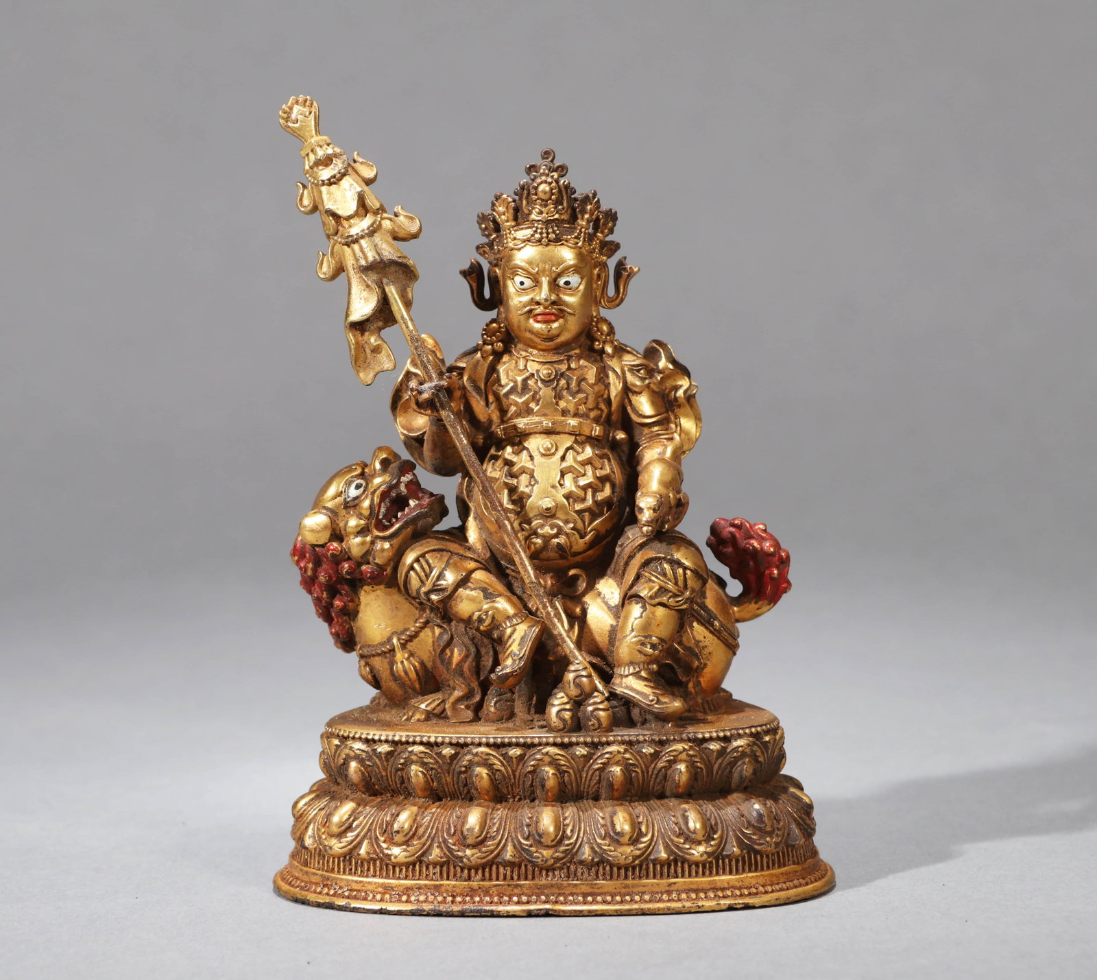 A GILT-BRONZE FIGURE OF VAISRAVANA: A GILT-BRONZE FIGURE OF VAISRAVANA Dimensions: Height: 10.5 cm (4.13 in.). All measurements are approximate.