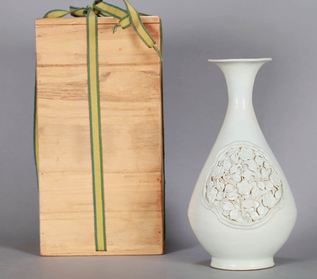 A WHITE-GLAZED CARVED 'FLOWERS' YUHUCHUN VASE: A WHITE-GLAZED CARVED 'FLOWERS' YUHUCHUN VASE Dimensions: Diameter: 24.5 cm (9.65 in.). All measurements are approximate.