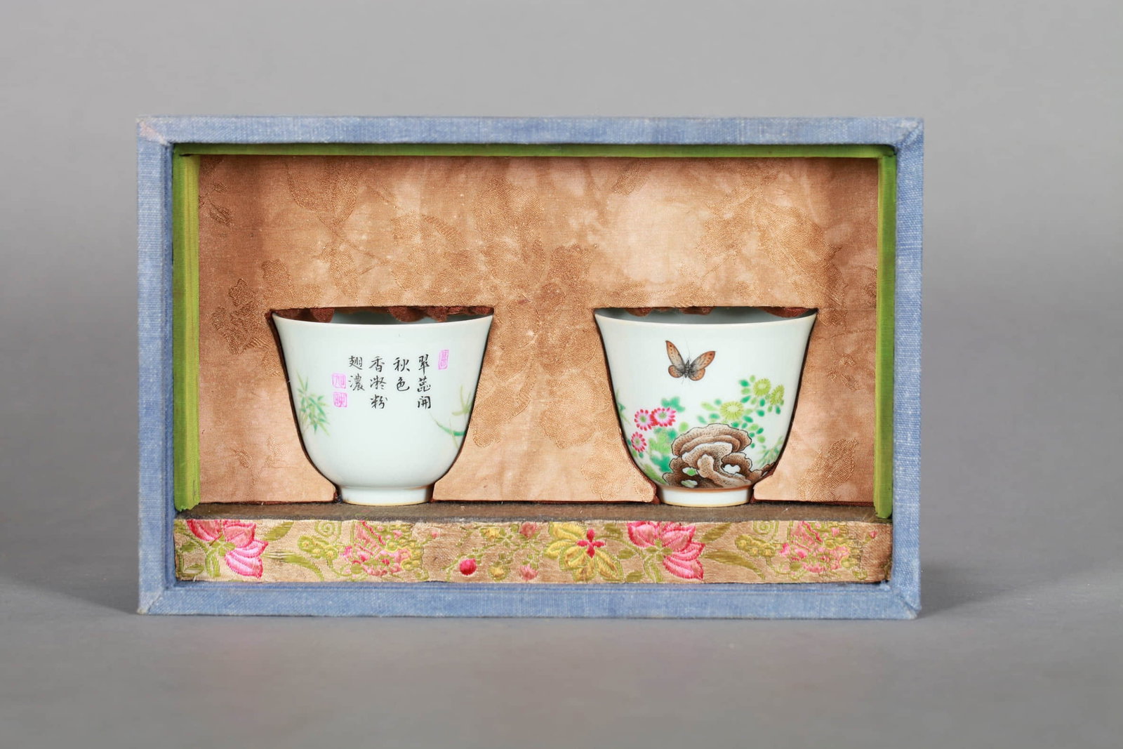 A PAIR OF ENAMEL 'FLOWERS, BUTTERFLIES AND POEM' CUPS: A PAIR OF ENAMEL 'FLOWERS, BUTTERFLIES AND POEM' CUPS Dimensions: Diameter: 6.5 cm (2.56 in.), Height: 5.5 cm (2.17 in.). All measurements are approximate.