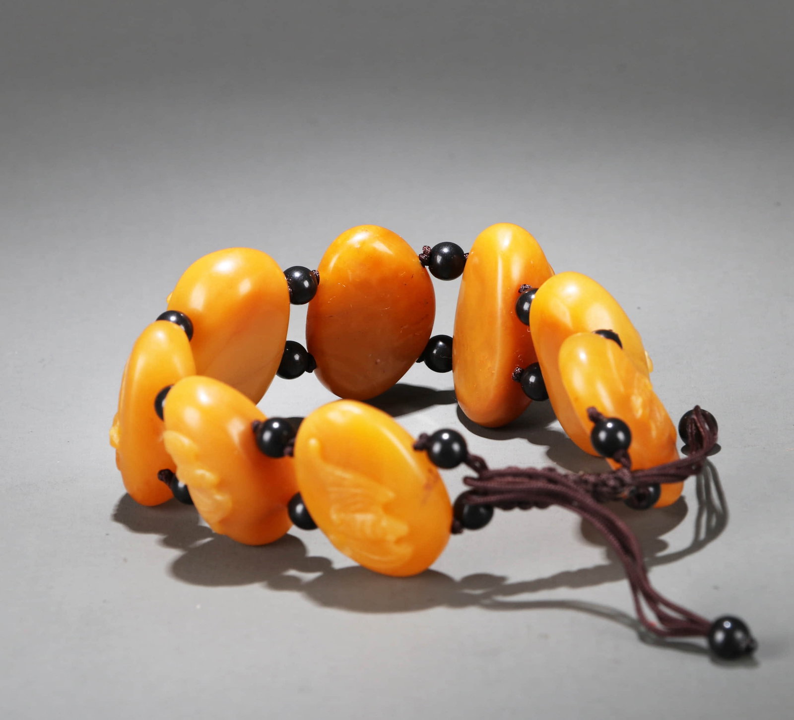 A TIANHUANG CARVED 'BAT AND COIN' BRACELET (1 of 7)