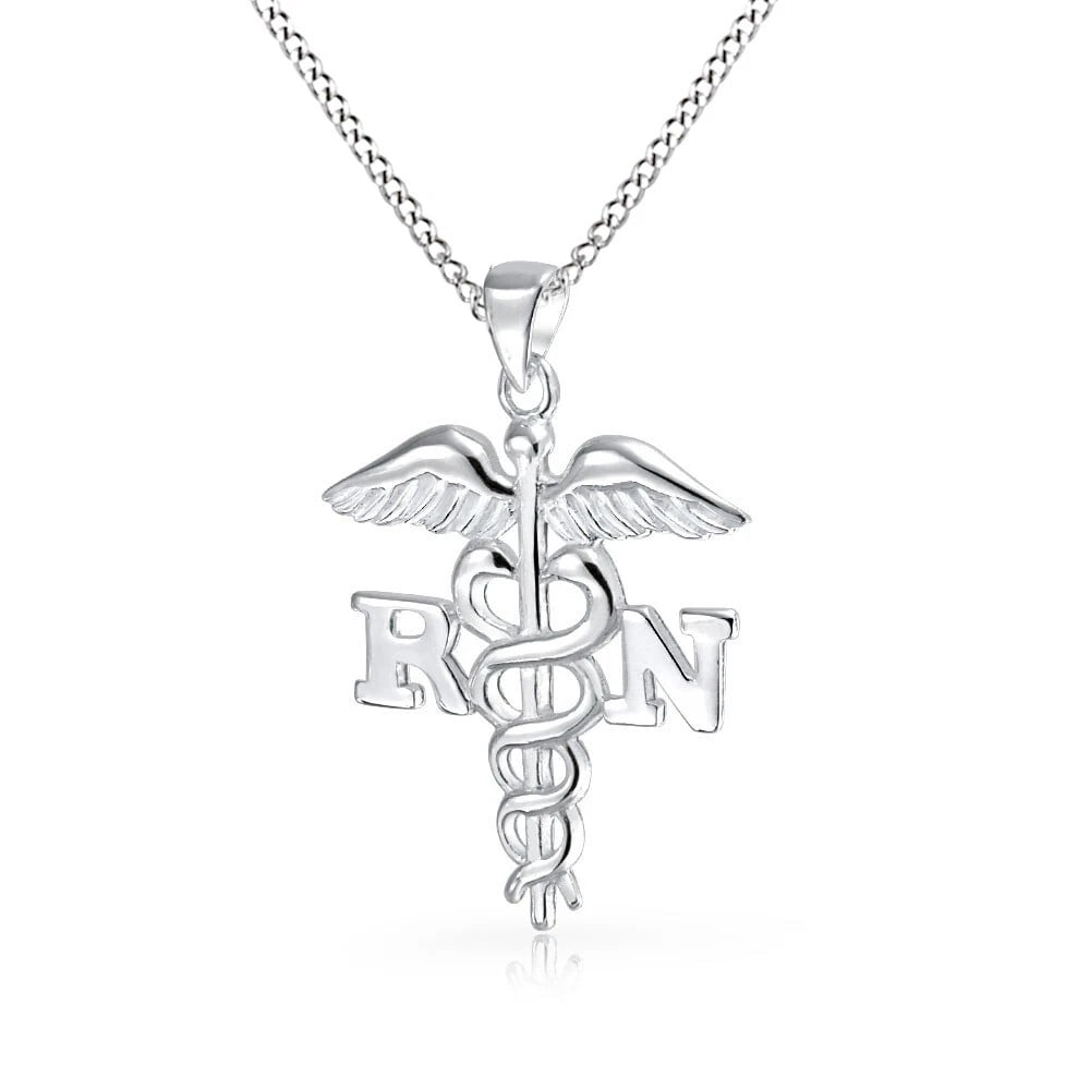 WHITE-METAL MEDICAL CADUCEUS-STYLE PENDANT NECKLACE: WHITE-METAL MEDICAL CADUCEUS-STYLE PENDANT NECKLACE Description: A white-metal pendant featuring a medical-symbol composition with winged staff, entwined serpents, and letter-like detailing,