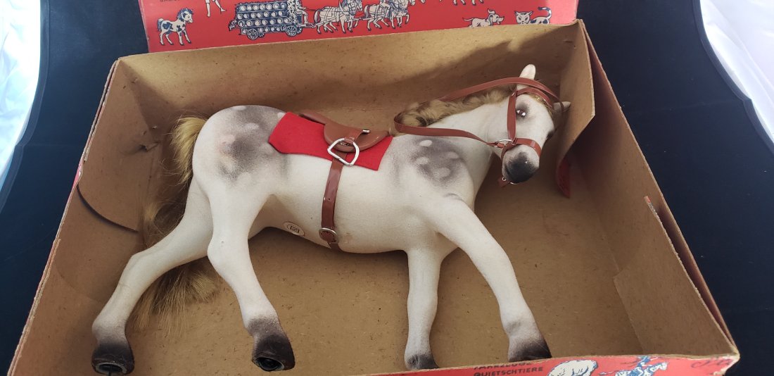 Vintage German Flocked Toy Horse on Wheels in original box: Vintage German Flocked Toy Horse on Wheels in original box. There are spots of discoloration on the flocking here and there and minor damage to toy and box- please take the time to see all of the phot
