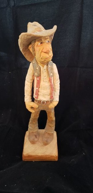 Wood Carving Cowboy American Flag Vest Signed G. Sears: Wood Carving Cowboy American Flag Vest Signed G. Sears. Stands 10" tall and 3" wide at base. Buyers Premium 20%. *In-House Shipping Available**