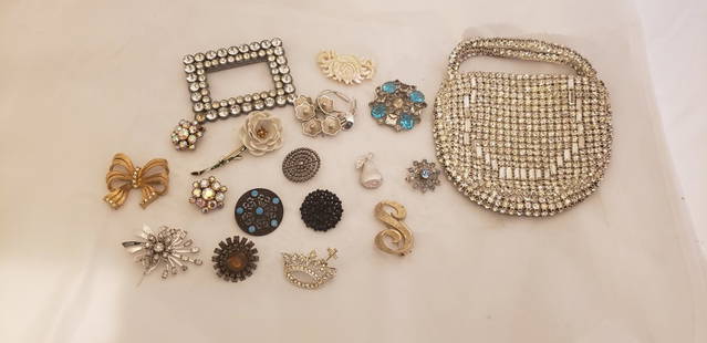 Antique Buttons and mixed Costume Jewelry lot: Antique Buttons and mixed Costume Jewelry lot. Very old decorative Buttons, a rhinestone purse, pair of rhinestone clip earrings and some nice brooches including a Crown Trifari piece. Buyers Premium