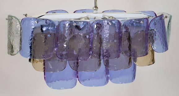 Carlo Nason for Mazzega Art Glass Chandelier: A Carlo Nason for Mazzega Murano oval art glass chandelier. Light has 6 sockets and three tiers. The top tier has 10 Amethyst colored blown glass curving shades flanked on each end by a colorless shad