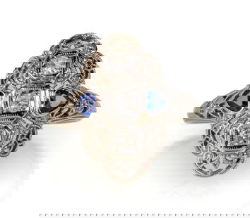 Art Deco 18k White Gold Diamond and Sapphire Ring: 18k white gold Art Deco elongated filigree ring with three round, brilliant cut, bead set diamonds (estimated at 0.04 ct. each) set in square settings and flanked by heart-shaped synthetic sapphires.