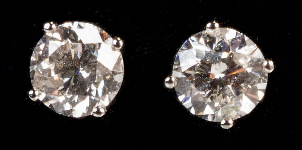 14k White Gold Diamond Stud Earrings: Pair of 14k white gold diamond stud earrings. Each is a round brilliant cut diamond set in a four-prong setting. One diamond is estimated to be 1.32 ct. and the other is estimated to be 1.30 ct. Estim