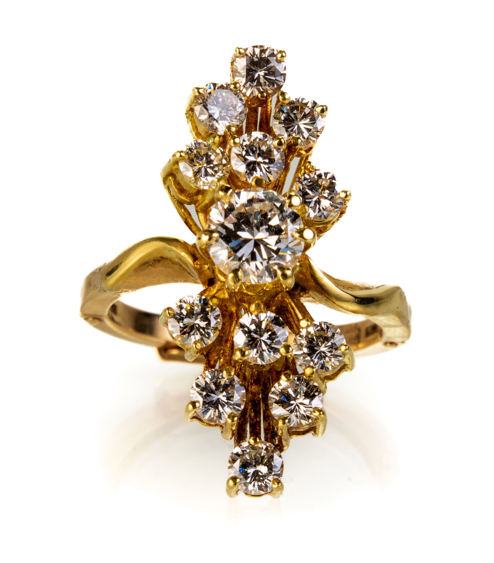 14k Yellow Gold Diamond Starburst Ring: 14k yellow gold ring with a starburst motif comprising of 12 prong set round cut diamonds (estimated to be 0.12 ct. each) with a prong set round cut diamond center stone (estimated to be 0.67 ct.). Al