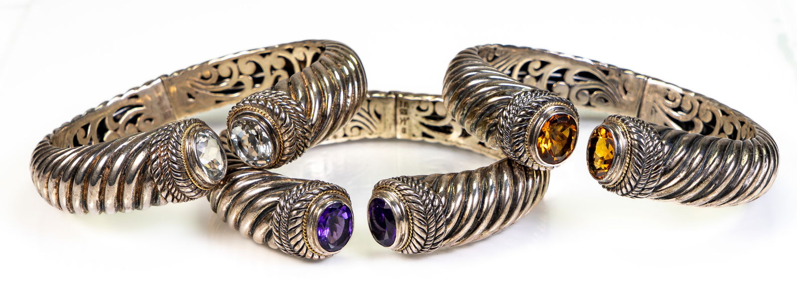 Three (3 ) Robert Manse Sterling Silver & 18k Gold Cuff Bracelets: Three (3) Bali RoManse signature sterling silver & 18k white gold cable cuff hinged bracelets, by Robert Manse. Each has a twisted cable design on the outside, a floral openwork on the inside, and all