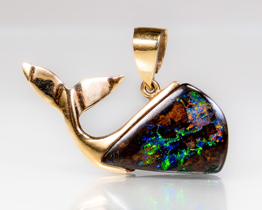 14k Gold Australian Opal Whale Pendant: 14k yellow gold whale pendant with a triangular shaped Australian opal. Measurements: 32 mm wide and 25 mm high (bale included) Markings: Marked 585 (for 14k) at the back of the bale, and signed "PJ".