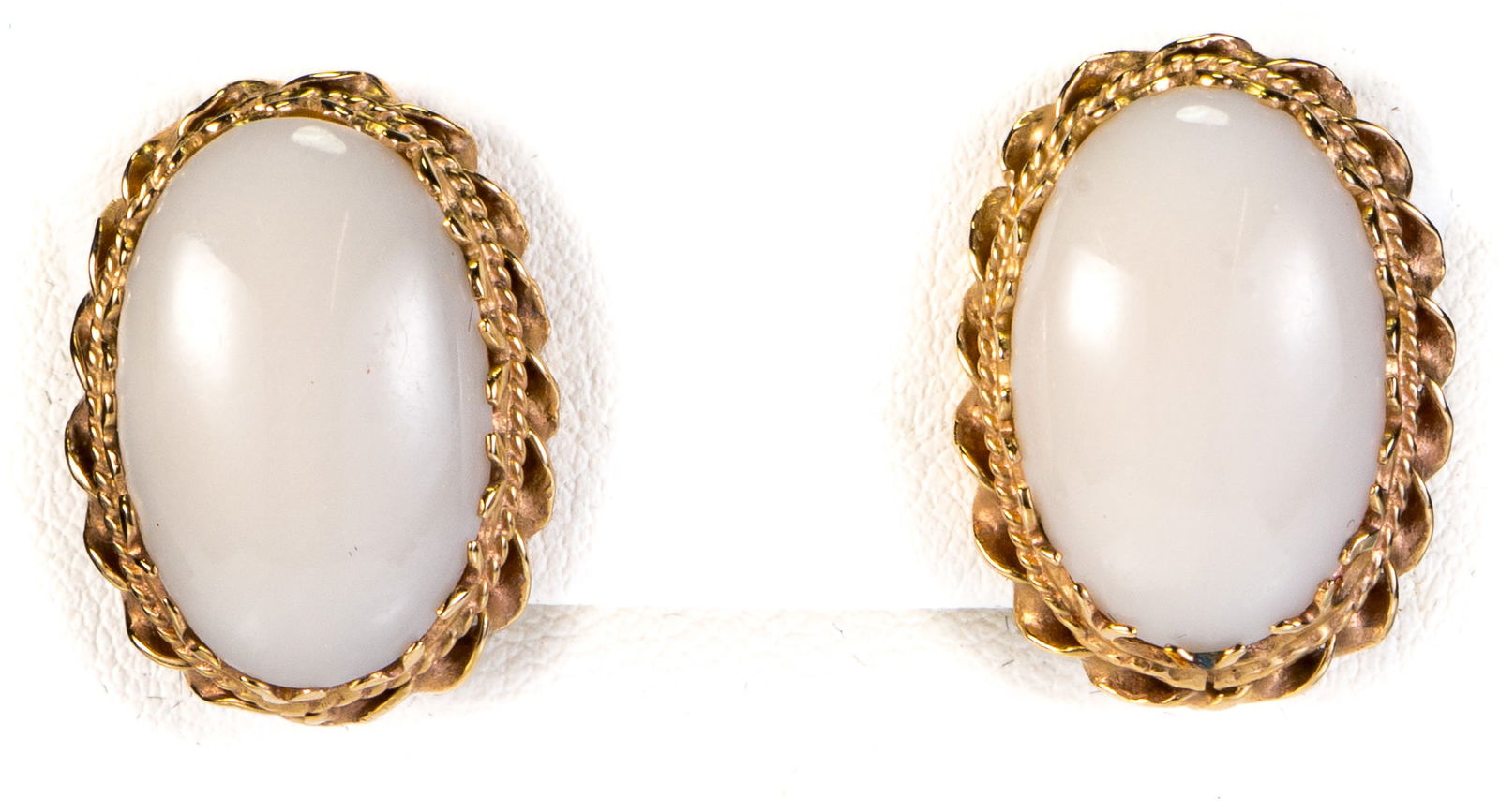 14k Gold Angel Skin Coral Earrings: Pair of 14k yellow gold and angel skin coral cabochon earrings (approximately 20 x 14 mm), with omega post backs. Measurements: Measuring overall 23mm x 18 mm. Markings: Marked "TH (?), 14k". Total we