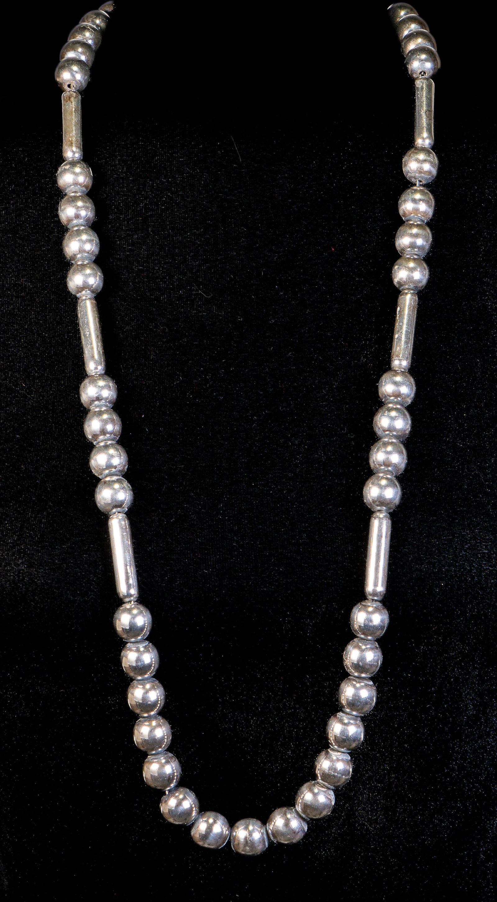 Sterling Silver Necklace: Sterling Silver necklace with beads and seven (7) elongated cylinders, ending with a box clasp. Measurements: Approximately 34 inches long. Markings: Marked "Sheila, 925, Mexico" on a metal tag, and "