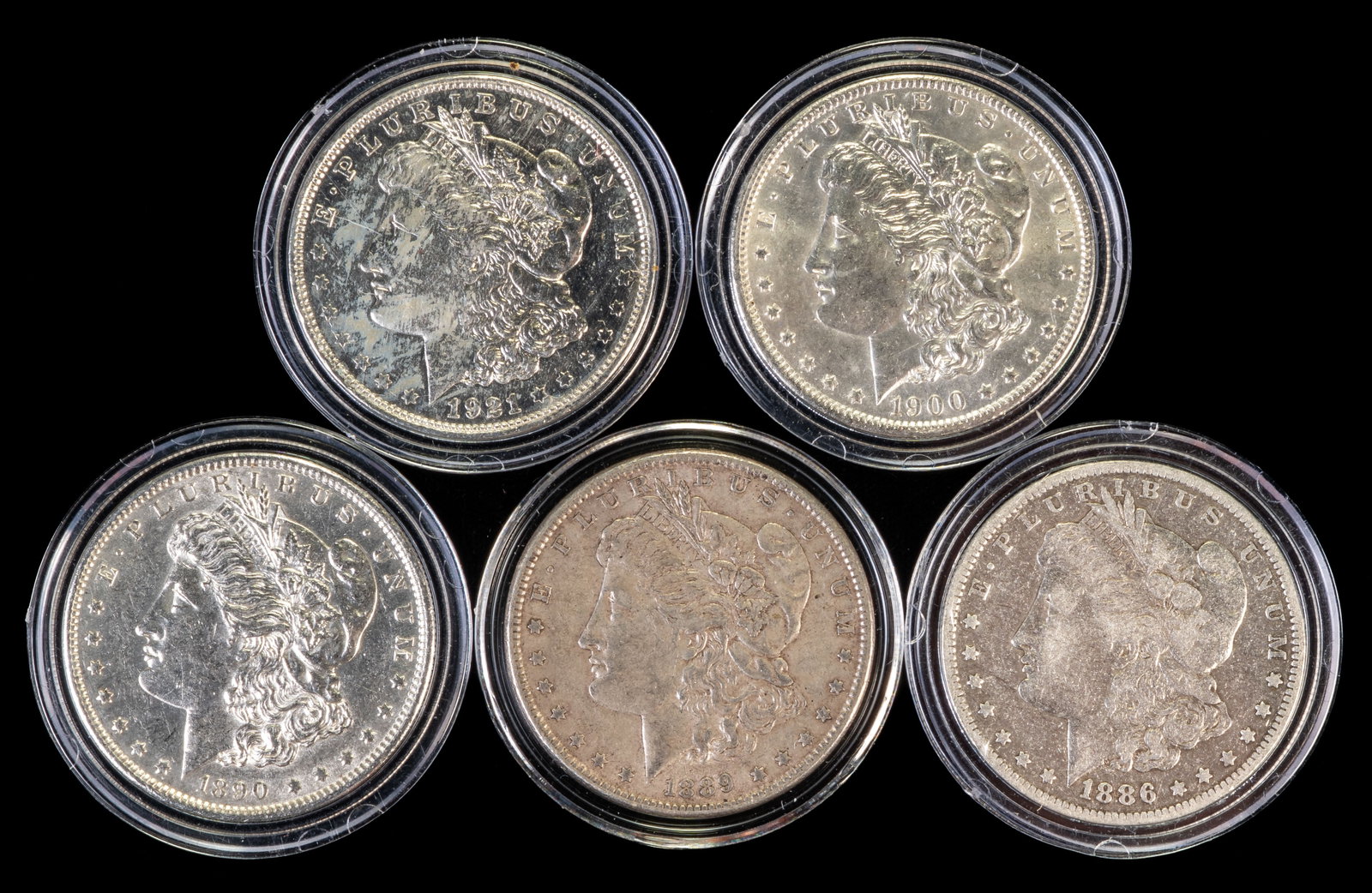 Five (5) Morgan Silver Dollars: Five (5) Morgan silver dollars. Years: 1886 O, 1889, 1890 S, 1900 O, 1921