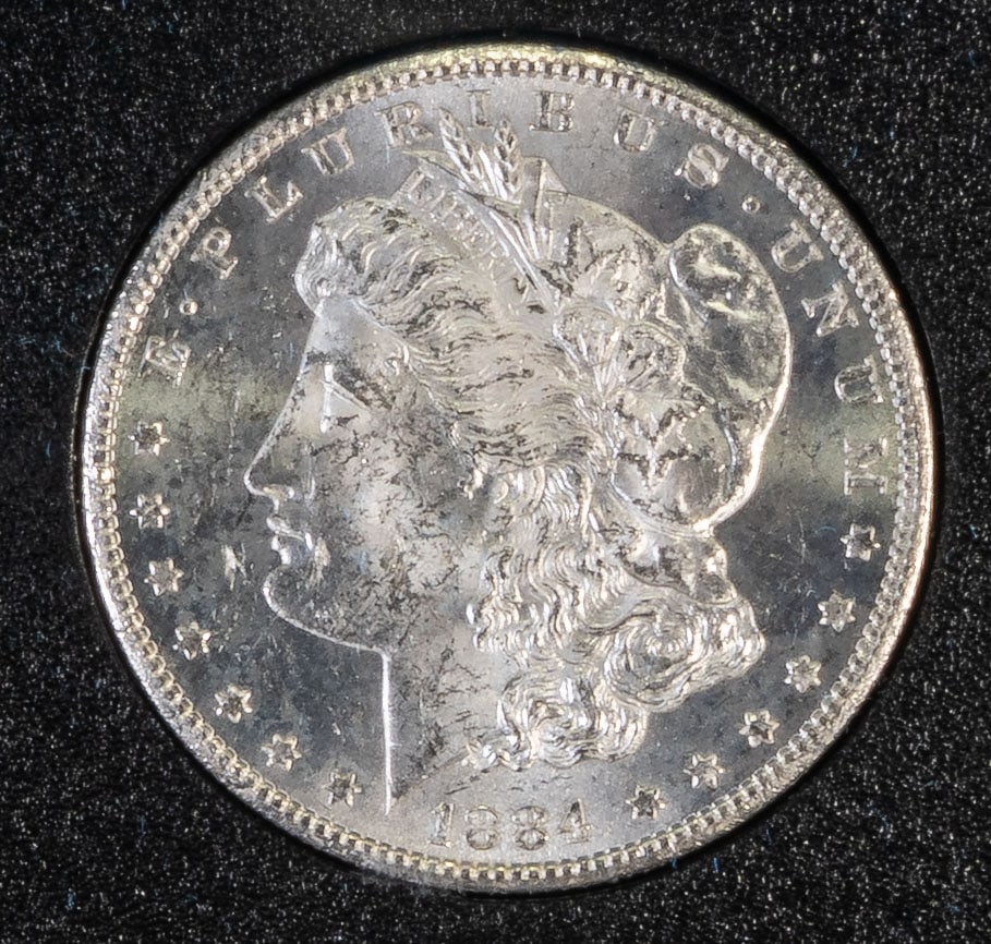 1884 Morgan Carson City Silver Dollar Uncirculated: An 1884 uncirculated Morgan Carson City silver dollar, with original box and paper.