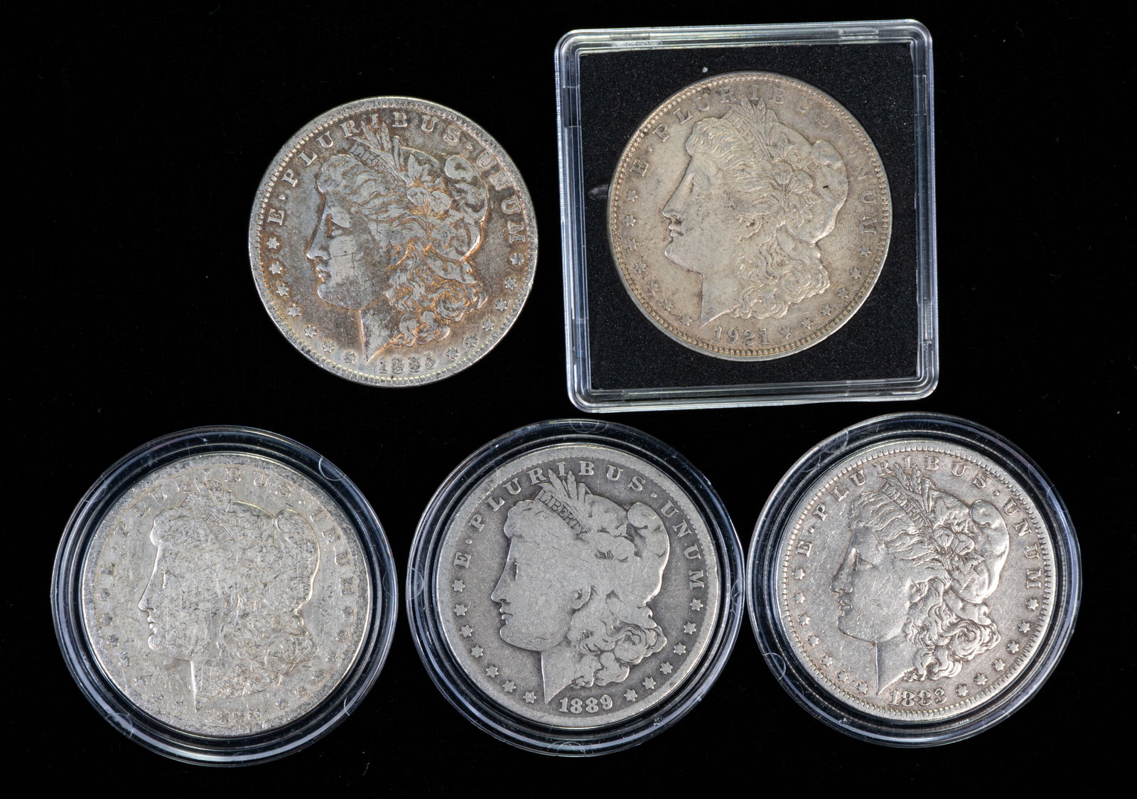 Five (5) Morgan Silver Dollars: Five (5) Morgan silver dollars. Years: 1883, 1885, 1889 O, 1890 O, 1921 D.