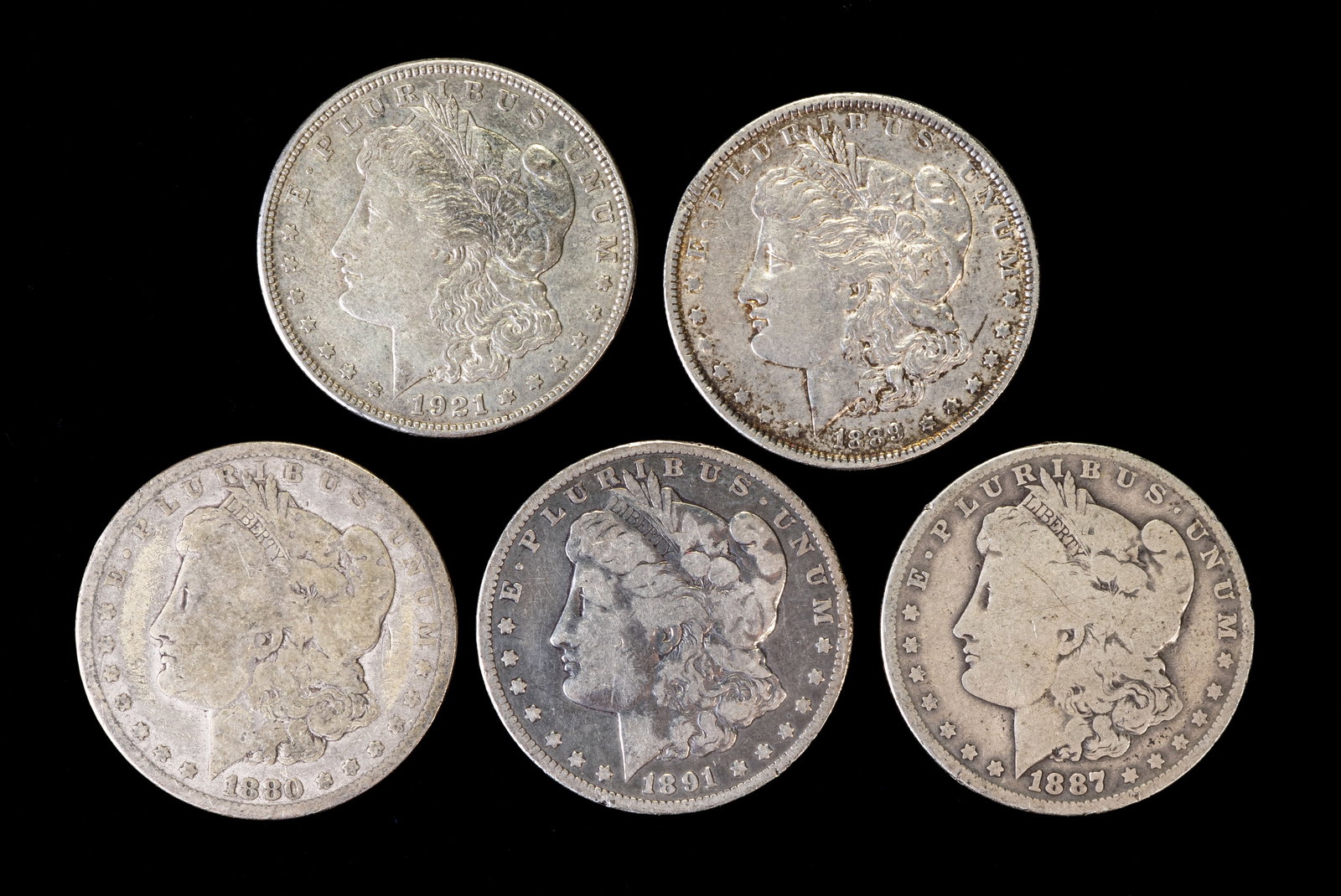 Five (5) Morgan Silver Dollars: Five (5) Morgan silver dollars. Years: 1880, 1887 O, 1889, 1891 O, 1921 D.