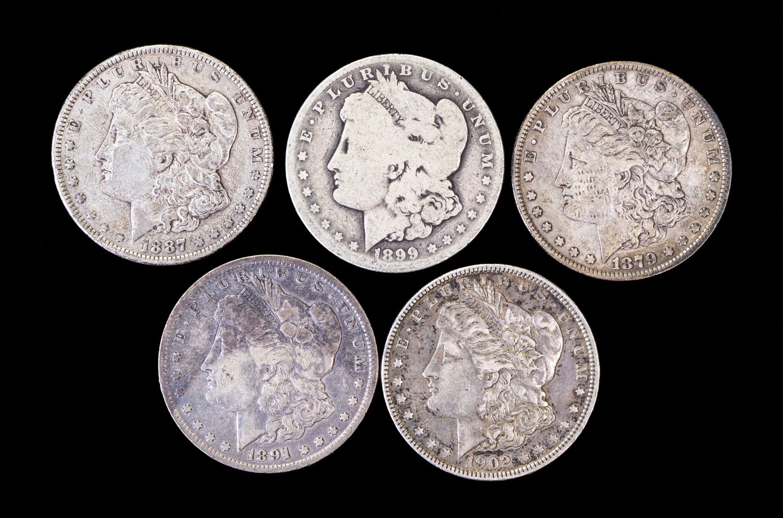 Five (5) Morgan Silver Dollars: Five (5) Morgan silver dollars. Years: 1879, 1887, 1899 O, 1891 O, 1902.