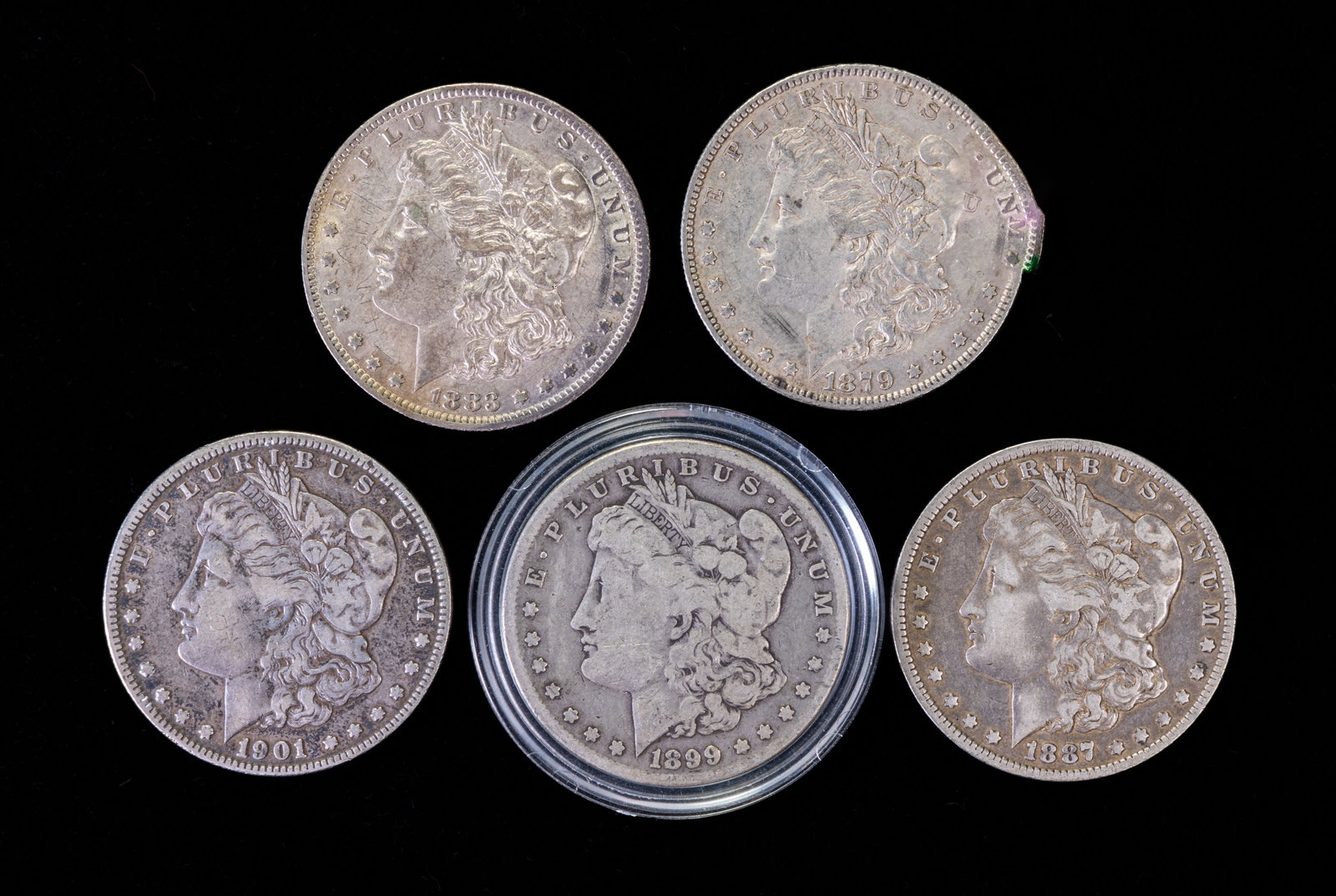 Five (5) Morgan Silver Dollars: Five (5) Morgan silver dollars. Years: 1879, 1883 O, 1887 O, 1899 O, 1901 O.