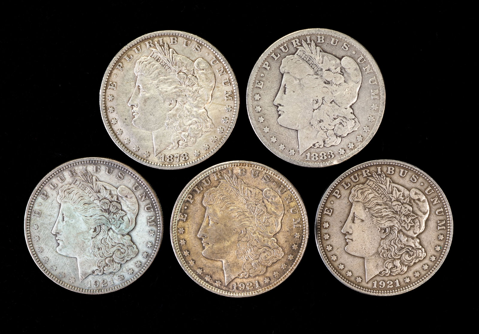 Five (5) Morgan Silver Dollars: Five (5) Morgan silver dollars. Years: 1878, 1883, three (3) 1921.
