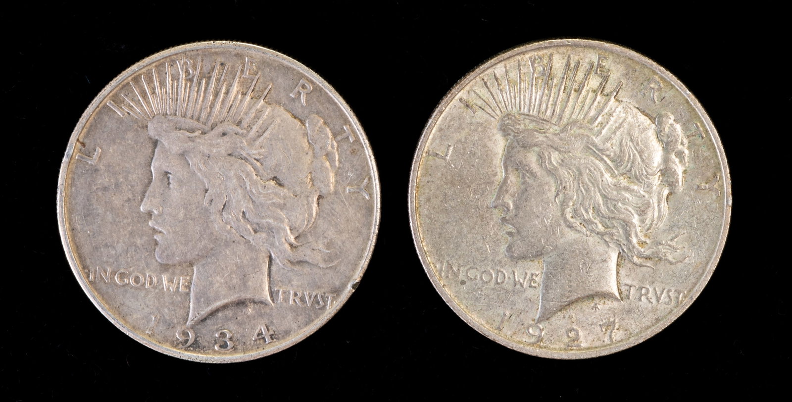 Two (2) LibertyPeace $1 Coins 1927D & 1934D: Two Liberty Peace $1 coins. Years: 1927 D and 1934 D.