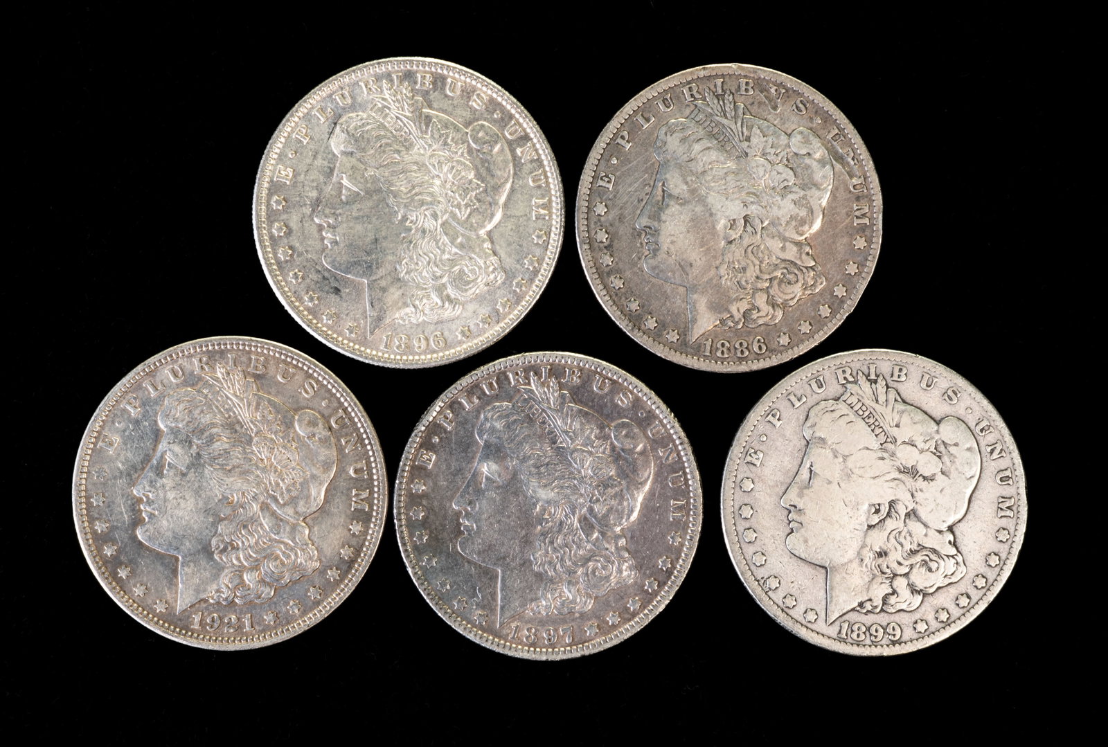 Five (5) Morgan Silver Dollars: Five (5) Morgan silver dollars. Years: 1886 O, 1896, 1897 O, 1899 O, 1921.