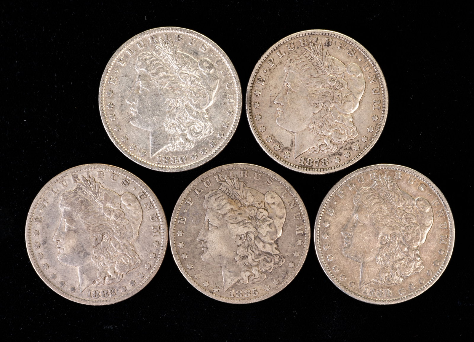 Five (5) Morgan Silver Dollars: Five (5) Morgan silver dollars. Years: 1878, 1880 O, 1882 O, 1885 O, 1888.
