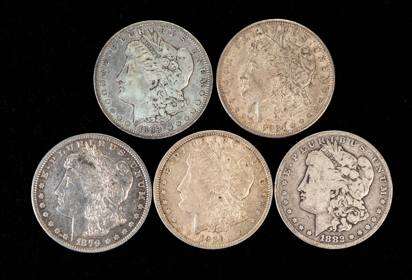 Five (5) Morgan Silver Dollars: Five (5) Morgan silver dollars. Years: 1879, 1882, 1889 O, 1921 S, 1921.