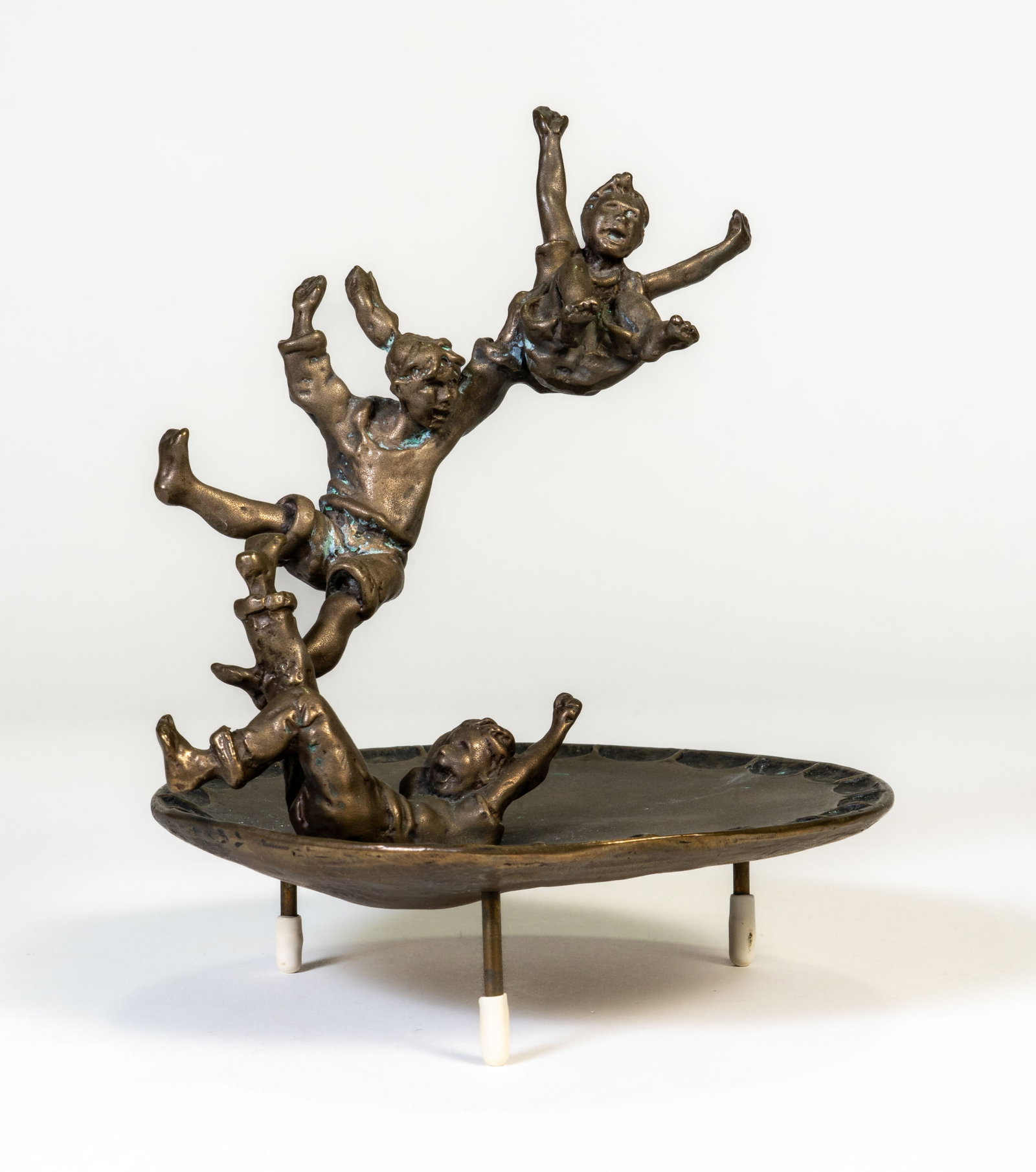 Mark Hopkins (American, NJ, b 1965) Jumpin: Jumpin' by Mark Hopkins (American, b 1965) Bronze sculpture of three children jumping on a trampoline. Limited edition 592/950. Copyright 98, signed Mark Hopkins. Measures 7 in. high x 5.25 in. wide.