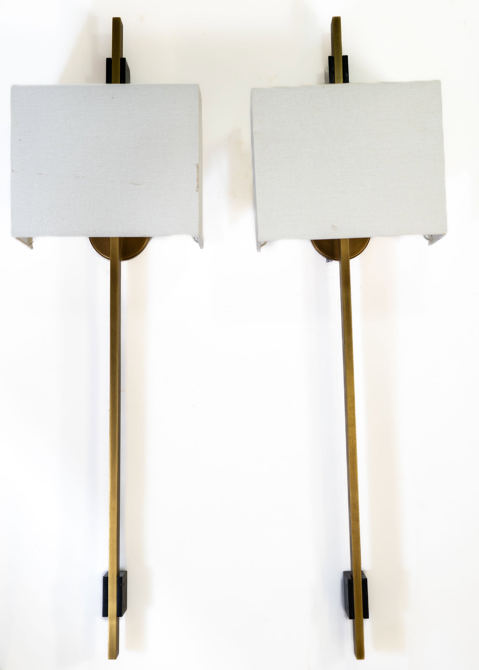 Pair RH Vela Vertical Brass Wall Sconces: Pair of Restoration hardware Vela wall sconces. Rectangular vertical rod, metal brackets have contrasting black chrome finish. Square form white linen shade. Measurements: 44 in. high x 12 in. wide