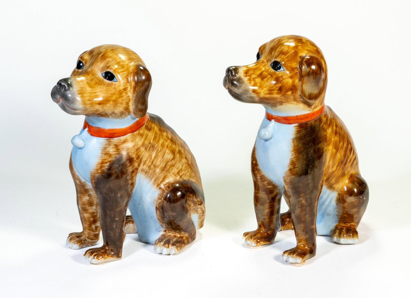 Pair Chinese Export Dog Figures: Pair of 20th c. Chinese export painted and glazed porcelain dog figures. Each 11 in. tall x 8 in. long. Very good condition. No scratches or damage.