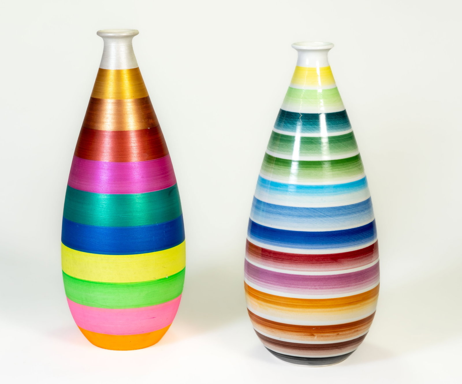 Two Bitossi, Italy, Pottery Vases: Two Bitossi pottery vases, Italy. Both with horizontal color bands; one glazed, one unglazed. Each 13 inches high. Both in good condition with no chips or losses. Unglazed vase shows minor surface