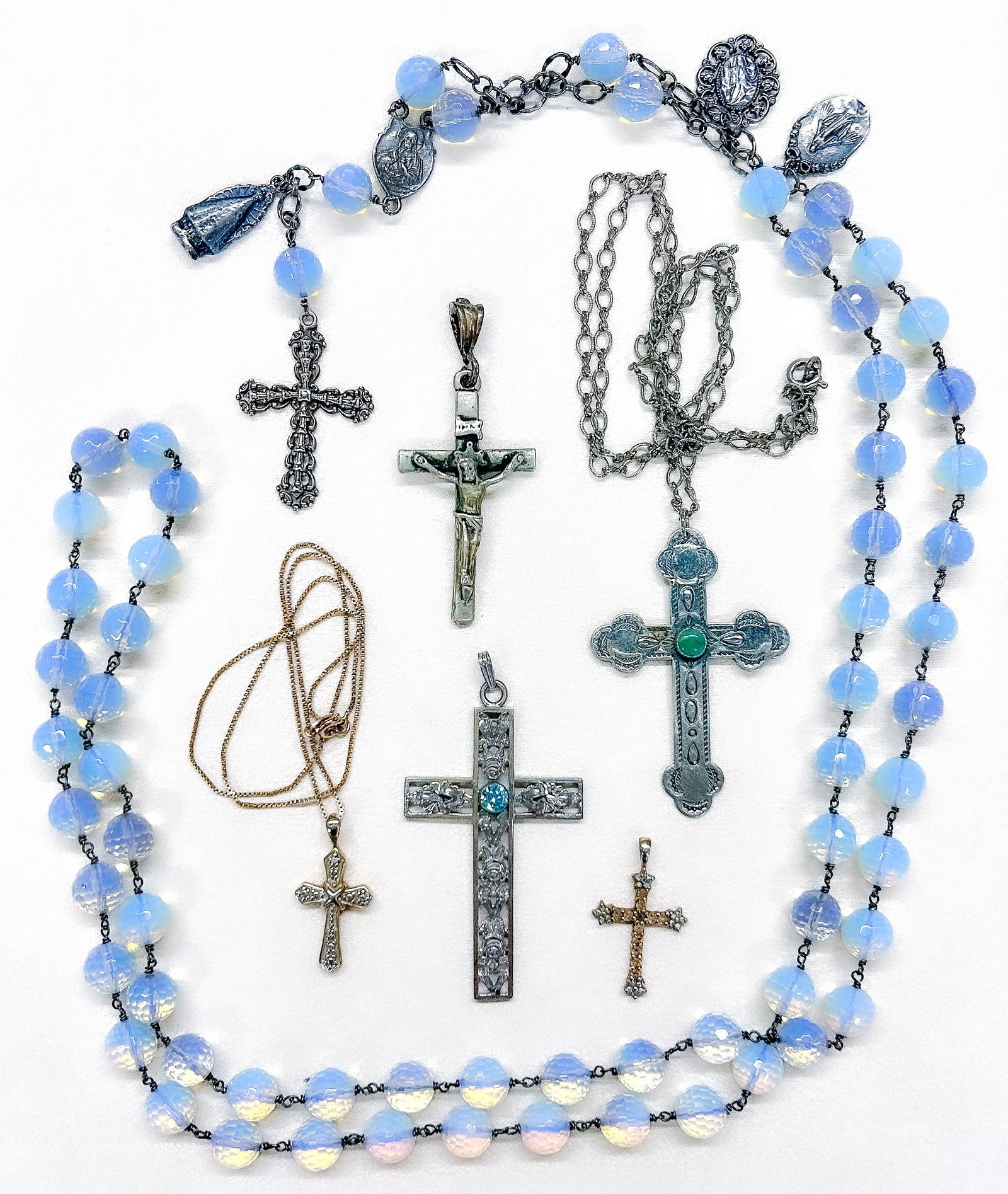 Sterling Silver Crosses: Six (6) sterling silver crosses, three without chains, and one rosary with milky faceted glass beads (marked "900" and "18k", tests positive for silver). Green?stone cross marked "sterling" (chain