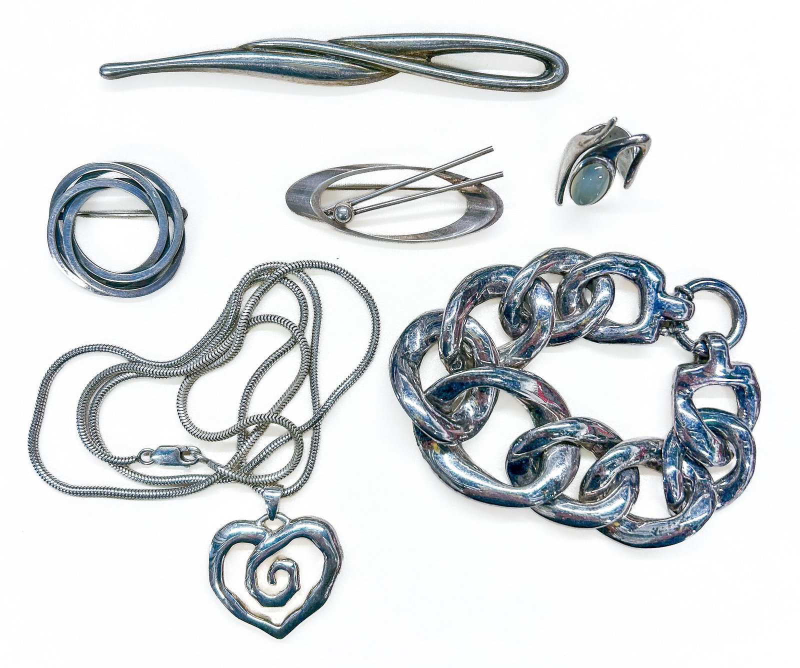 Sterling Silver Jewelry: Six (6) Modernist sterling silver pieces: three bar pins (N.E. From Denmark; Bayanihan; Denmark M.S.), heart pendant necklace (Thailand), graduated link bracelet (Thailand), and moonstone ring (size