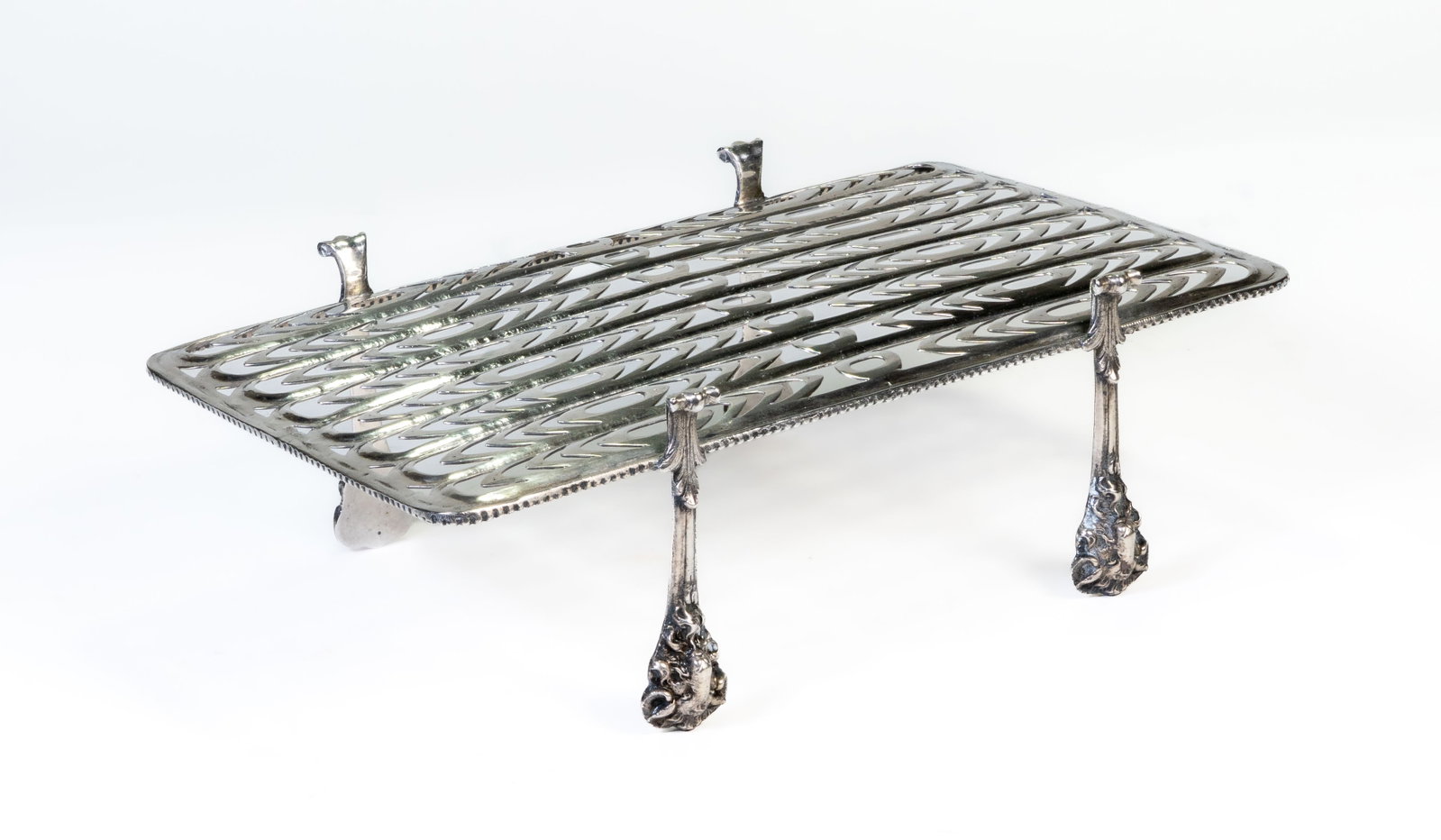 19th C French Silver Asparagus Tray: 19th?century French fully hallmarked sterling silver asparagus tray. Reticulated, lion?head and paw feet. Weight: 10.44 ozt. Measures 3 1/8 in. H x 9 3/8 in. L x 5 5/8 in. W. |