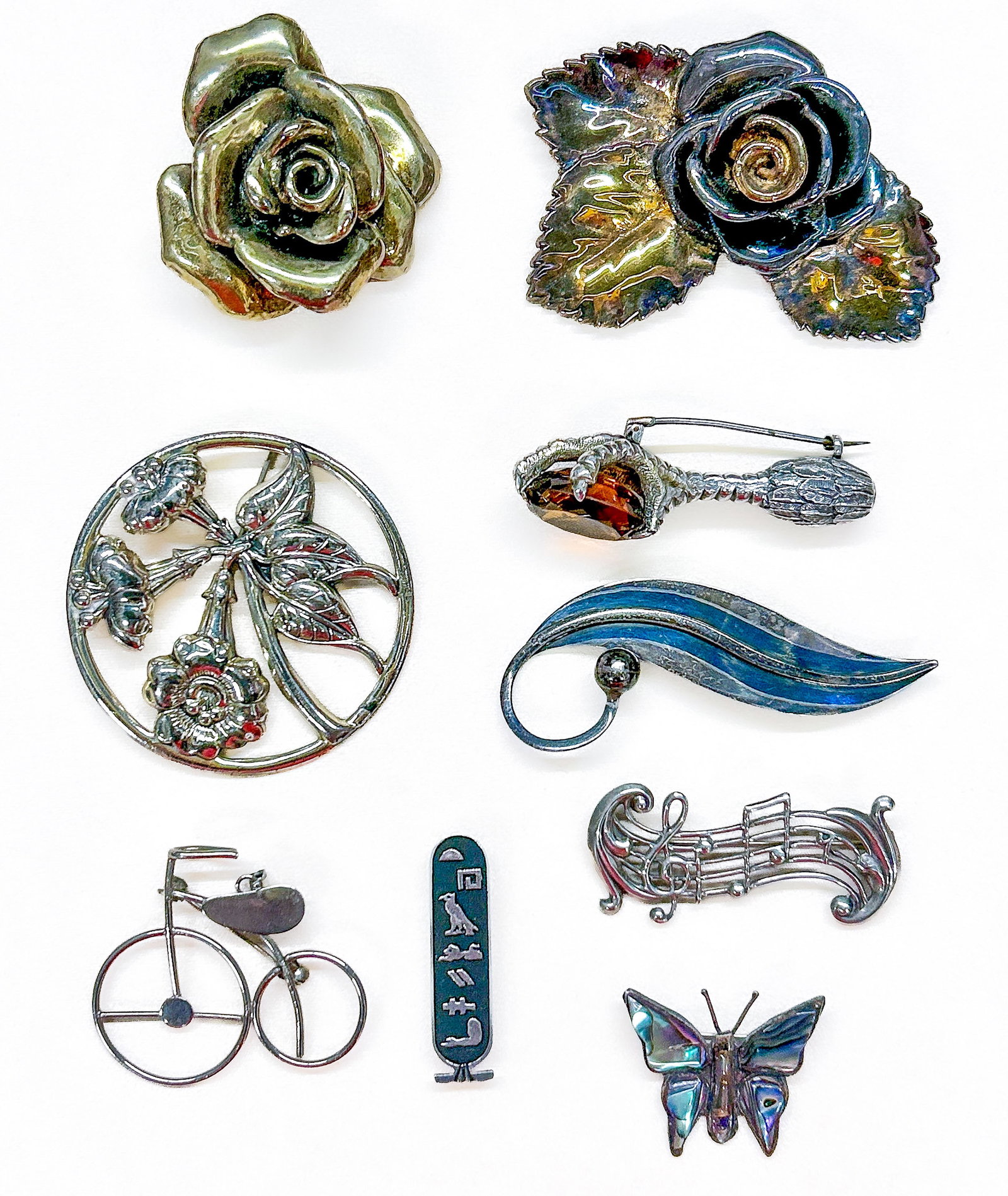 Sterling Silver Brooches: Nine (9) brooches: rose bar pin ("925"), rose/leaf bar pin (tested positive), Danecraft rose bar pin, rooster claw with quartz (tested positive), Taxco leaf brooch ("C.925, Delfino"), unmarked bike