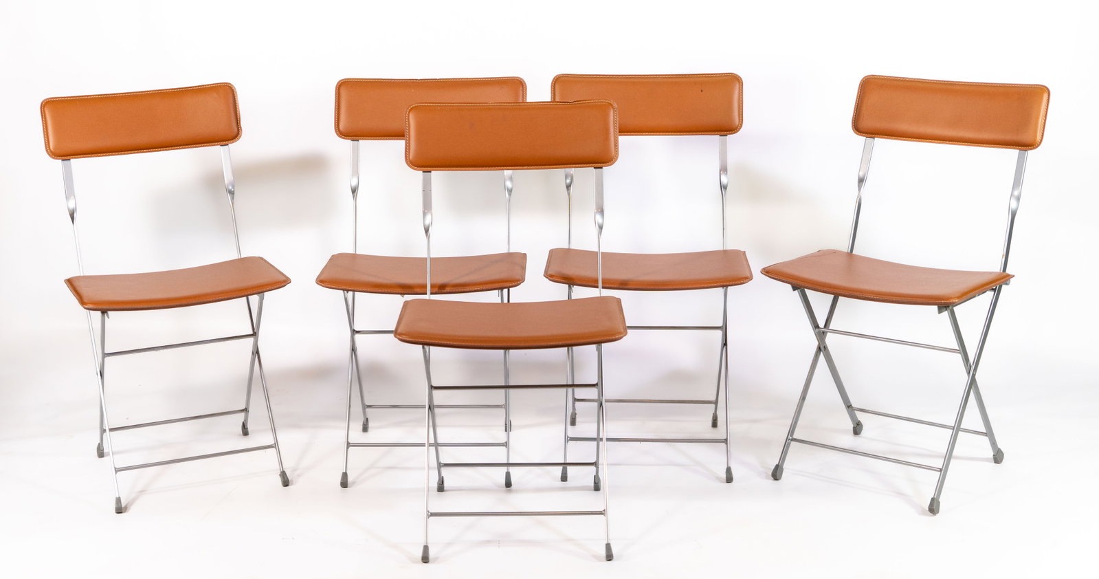 Five (5) DWR "Lina" Italian Leather Folding Chairs: Set of five (5) Design Within Reach (DWR) ?Lina? leather folding chairs, brown leather and steel, labeled ?Made in Italy?. Dimensions: Height 32 in; Width 17.25 in; Depth 18 in; Seat height 17 in. Pro