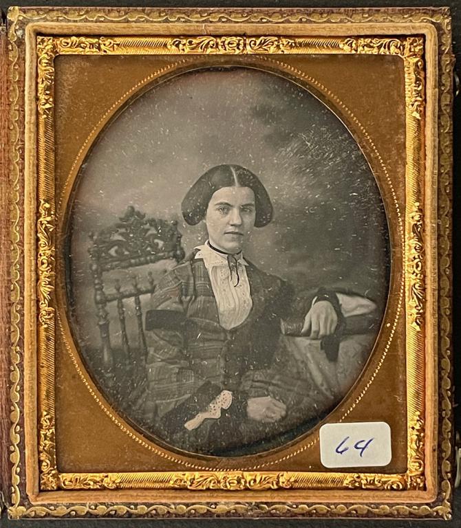 [DAGUERREOTYPE] LOT OF 6 PORTRAITS OF YOUNG LADIES: Lot of 6 daguerreotypes with portraits of young ladies, including one by John Plumbe: John Plumbe [Woman with parasol and shawl] Sixth plate daguerreotype, early J. Plumbe case. 1845 Found in N. Maryl