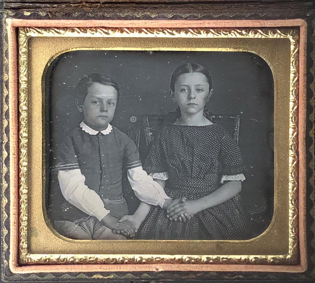 [DAGUERREOTYPE] SIBLING PORTRAIT CROSSED HANDS: Beautiful image of possibly siblings. Unknown daguerreotypist [Siblings holding crossed hands] SIxth plate tinted daguerreotype Papier Mache case Provenance note: found in NY around 1981. Additional i