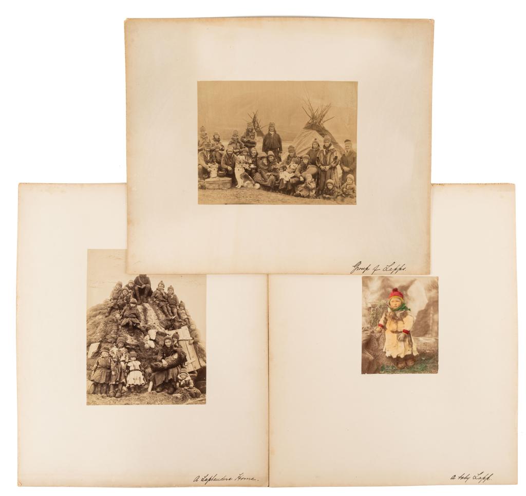 [PRINTS] LAPLANDER. LOT OF 3 ALBUMEN SOLD TOGETHER: LAPLANDER. A lot of 3 albumen prints sold together. Including a photograph of a group of children arranged on a hill/mound; families with children and dogs arranged around tent; coloured print of a ch