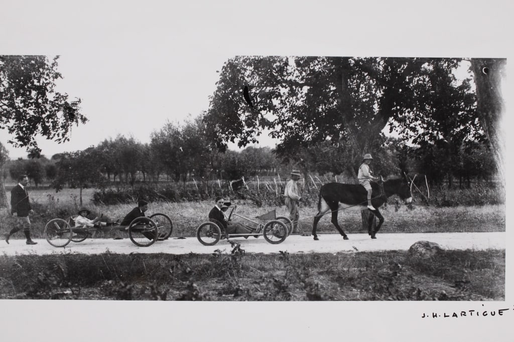 LARTIGUE, JACQUES HENRI. KART RACERS. (1911): LARTIGUE, J.H. (Jacques Henri). KART RACERS. 1911, printed later. Silver print. Signed by Lartigue in marker on bottom right. Lartigue's copyright stamp on verso. Print: 17 x 36; sheet: 40 x 50 cm. Ge