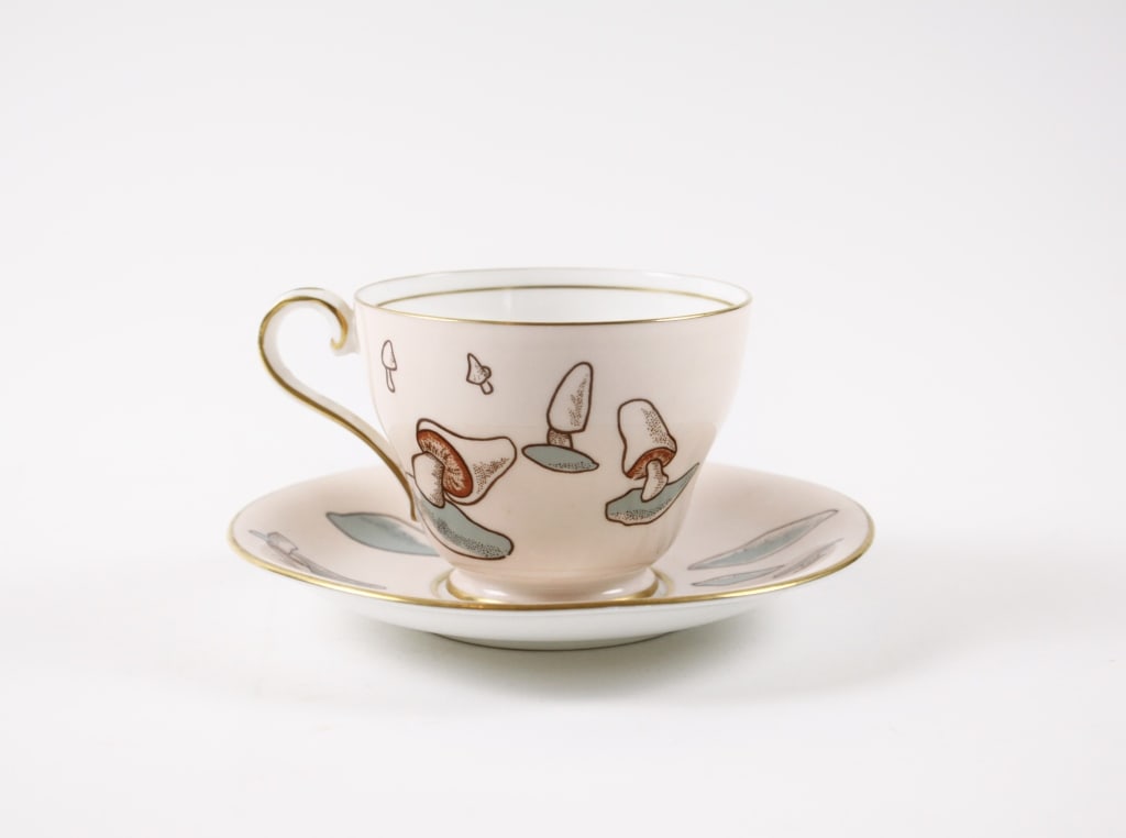 TEA CUP AND SAUCER, MUSHROOM DESIGN. AYNSLEY: TEA CUP AND SAUCER, MUSHROOMS. Aynsley England bone China, 31 (marked on tea cup). Generally very good condition, various imperfections. *Additional images and detailed condition report available upon